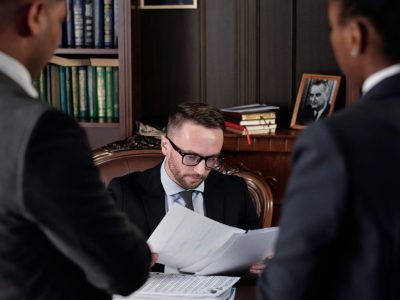 Business professionals discussing important legal documents in an office setting.